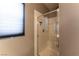 Walk-in shower with glass door, seat, and tiled walls at 1056 Sweeping Ivy Ct, Las Vegas, NV 89183