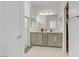 Bathroom with dual vanity, ample lighting, and a modern shower at 1103 Tektite Ave, Henderson, NV 89011