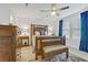 Bedroom featuring wooden furniture, ceiling fan, plush carpet, and large windows with blue curtains at 1103 Tektite Ave, Henderson, NV 89011