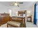 Main bedroom showcasing wooden furniture, ceiling fan, and plush carpet; abundant natural light fills the room at 1103 Tektite Ave, Henderson, NV 89011