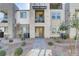 Exterior view of a modern townhouse featuring stone accents and a small front yard at 1103 Tektite Ave, Henderson, NV 89011