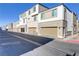 Modern townhome exterior with attached garages and neutral color scheme at 1103 Tektite Ave, Henderson, NV 89011