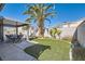 Spacious backyard with a covered patio, swimming pool, and lush tropical landscaping at 1110 Legato Dr, Las Vegas, NV 89123