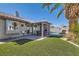 Inviting backyard space featuring a covered patio, swimming pool, and manicured artificial lawn at 1110 Legato Dr, Las Vegas, NV 89123