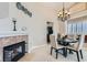 Cozy dining area with modern chandelier, fireplace and neutral décor at 1110 Legato Dr, Las Vegas, NV 89123