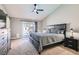 Modern bedroom with a king-size bed, ceiling fan, and sliding glass doors to the backyard at 1110 Legato Dr, Las Vegas, NV 89123