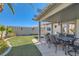 Cozy covered patio with outdoor dining area and lush lawn, perfect for entertaining at 1110 Legato Dr, Las Vegas, NV 89123