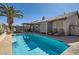 Backyard pool with a covered patio, lounge chairs, and palm trees, perfect for relaxation at 1110 Legato Dr, Las Vegas, NV 89123