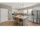 Modern kitchen featuring white cabinetry, stainless steel appliances, and a center island with bar seating at 11256 Rainbow Peak Ave # 207, Las Vegas, NV 89135