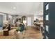 Open-concept living room with stylish furnishings and wood-look tile flooring extending to the kitchen at 11256 Rainbow Peak Ave # 207, Las Vegas, NV 89135