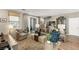 Well-lit living room featuring a comfortable seating arrangement, neutral color palette, and wood-look floors at 11256 Rainbow Peak Ave # 207, Las Vegas, NV 89135