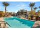 Inviting community pool area with comfortable lounge chairs, perfect for relaxation and socializing at 11256 Rainbow Peak Ave # 207, Las Vegas, NV 89135