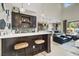 Stylish bar area featuring dark wood cabinets, a white countertop, and pendant lighting at 12054 Portamento Ct, Las Vegas, NV 89138