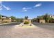 View of the gated entrance featuring masonry walls and manicured landscaping under a bright blue sky at 12054 Portamento Ct, Las Vegas, NV 89138