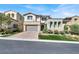 Stunning two-story home with a brick driveway and meticulously landscaped front yard at 12054 Portamento Ct, Las Vegas, NV 89138