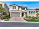 Beautiful home featuring a paver driveway, two-car garage, and charming landscaping at 12054 Portamento Ct, Las Vegas, NV 89138