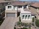 Elegant two-story home showcasing stone accents, manicured landscaping and a paved driveway at 12054 Portamento Ct, Las Vegas, NV 89138