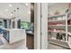 Modern kitchen view showcasing an island with a marble waterfall countertop and a walk-in pantry at 12054 Portamento Ct, Las Vegas, NV 89138