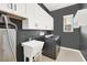 Functional laundry room with ample storage, a utility sink, and modern washer and dryer at 12054 Portamento Ct, Las Vegas, NV 89138