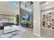 Open-concept living room with a decorative accent wall and built in shelving, creating a modern and cozy space at 12054 Portamento Ct, Las Vegas, NV 89138