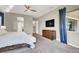 Main bedroom featuring tray ceilings, carpeted floors, and a ensuite bath with walk-in closet at 12054 Portamento Ct, Las Vegas, NV 89138