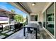 Covered outdoor dining area featuring a long table, chairs, grill, and fireplace at 12054 Portamento Ct, Las Vegas, NV 89138