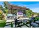 Outdoor kitchen with grill, fireplace, sink, refrigerator, and seating area at 12054 Portamento Ct, Las Vegas, NV 89138