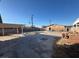 Wide shot of a backyard with an unfinished pool and a covered patio area at 1275 Westwind Rd, Las Vegas, NV 89146