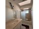 Bathroom showcasing a single sink vanity and a shower/tub combo with tan tiling at 1275 Westwind Rd, Las Vegas, NV 89146