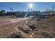 Wide angle of the home's front yard with a bright, sunny sky at 1275 Westwind Rd, Las Vegas, NV 89146