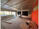 Unfinished living room with red brick wall accents, large windows, and a drop ceiling at 1275 Westwind Rd, Las Vegas, NV 89146