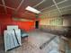 Unfinished living room with a brick wall, drop ceiling, and mixed flooring at 1275 Westwind Rd, Las Vegas, NV 89146