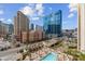 Stunning aerial view of the city skyline and pool area surrounded by many palm trees at 135 E Harmon Ave # 701, Las Vegas, NV 89109