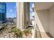 Balcony view featuring a pool, surrounding palm trees, and neighboring buildings at 135 E Harmon Ave # 701, Las Vegas, NV 89109