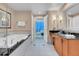 Elegant bathroom featuring a vanity, a soaking tub and tile floors that give a touch of modern style at 135 E Harmon Ave # 701, Las Vegas, NV 89109