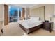 Bedroom featuring a large bed with city views from the expansive windows at 135 E Harmon Ave # 701, Las Vegas, NV 89109