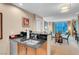 Modern kitchen features stainless steel appliances and bar seating with the living room in the background at 135 E Harmon Ave # 701, Las Vegas, NV 89109