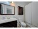 Well-lit bathroom features a vanity with dark wood cabinets, and shower with curtain at 1421 Hometown Ave, Henderson, NV 89074