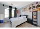 Bedroom with a black bed frame, stylish accents, wood-look flooring, and natural light at 1421 Hometown Ave, Henderson, NV 89074