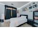 Bedroom with a black bed frame, stylish accents, wood-look flooring, and natural light at 1421 Hometown Ave, Henderson, NV 89074