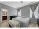 A serene bedroom features ensuite bath and neutral walls, bathed in soft, natural light at 1421 Hometown Ave, Henderson, NV 89074