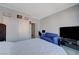 Bedroom featuring white bedding, wood-look floors, and a workspace at 1421 Hometown Ave, Henderson, NV 89074