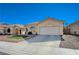 Inviting single-story home with manicured lawn and desert landscaping, complemented by a two-car garage at 1421 Hometown Ave, Henderson, NV 89074