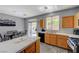 A combined kitchen and dining area with backyard access via sliding glass doors at 1421 Hometown Ave, Henderson, NV 89074