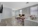 Cozy living room with a large sectional sofa, decorative accents, and wood-look tile flooring at 1421 Hometown Ave, Henderson, NV 89074