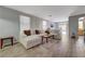 Spacious living room featuring a large sectional sofa, stylish decor, and wood-look tile flooring at 1421 Hometown Ave, Henderson, NV 89074