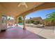 Inviting backyard patio with a covered dining area, pool, spa and lush tropical landscaping creates an outdoor oasis at 1426 Clipperton Ave, Henderson, NV 89074