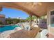 Inviting backyard patio with a covered dining area overlooking the pool is perfect for entertaining at 1426 Clipperton Ave, Henderson, NV 89074