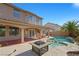 Inviting backyard with a covered patio, pool, spa and lush tropical landscaping creates an outdoor oasis at 1426 Clipperton Ave, Henderson, NV 89074