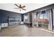 Chic bedroom featuring dark accent walls, wood-look floors, and abundant natural light, creating a serene retreat at 1426 Clipperton Ave, Henderson, NV 89074